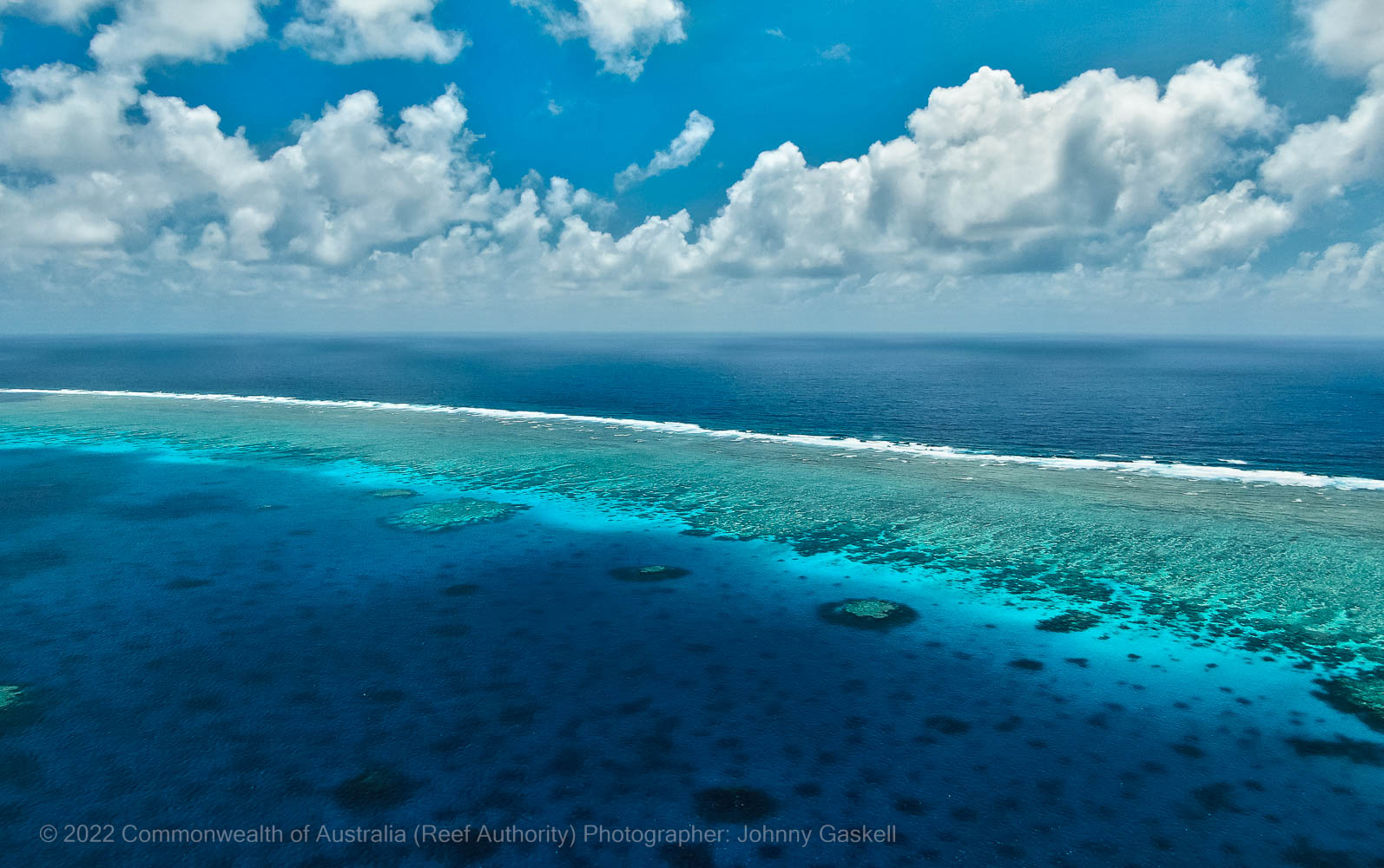 Aerial photograph of the Great Barrier Reef and deep ocean – © Commonwealth of Australia – (Reef Authority) - Photographer: Johnny Gaskell