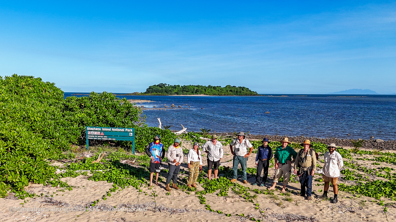 A group of people standing on a beach