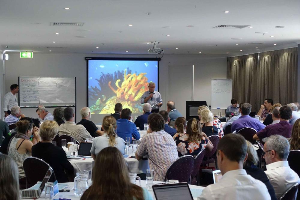 Group of people listening to presentation at summit