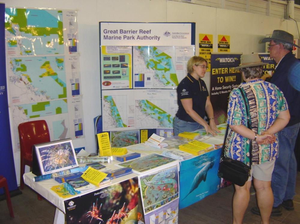 A Reef Authority staff member at booth with various maps and brochures during public consultation